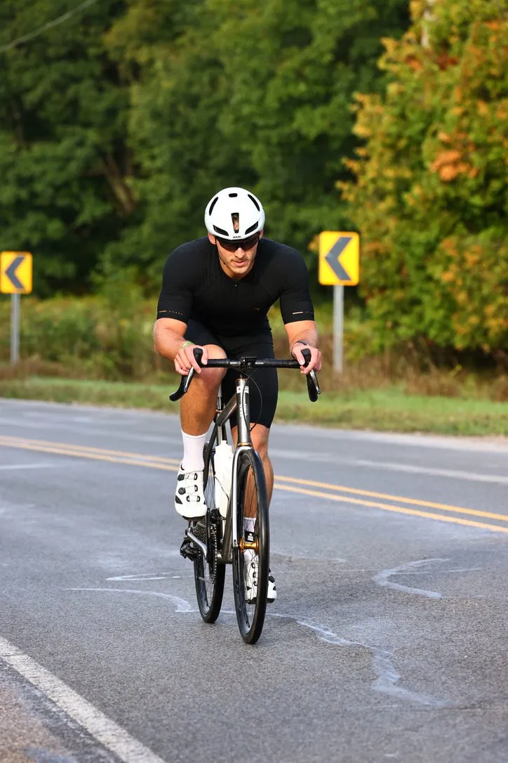 James riding his road bike toward the camera on the bike course