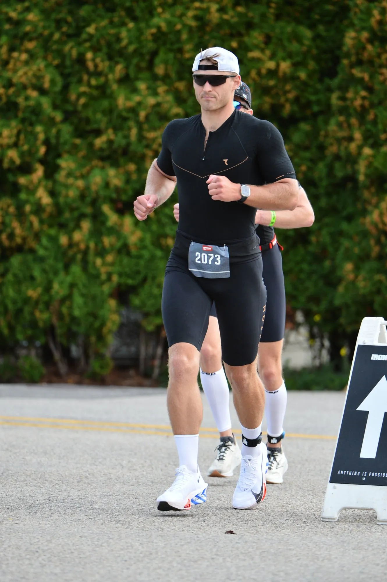James running on the run course wearing bib 2073